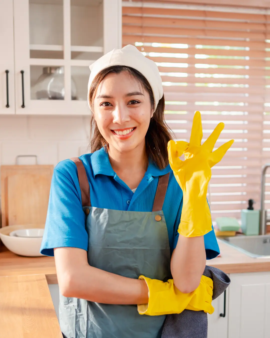 Girl Smiling and Holding Cleanign Supplies